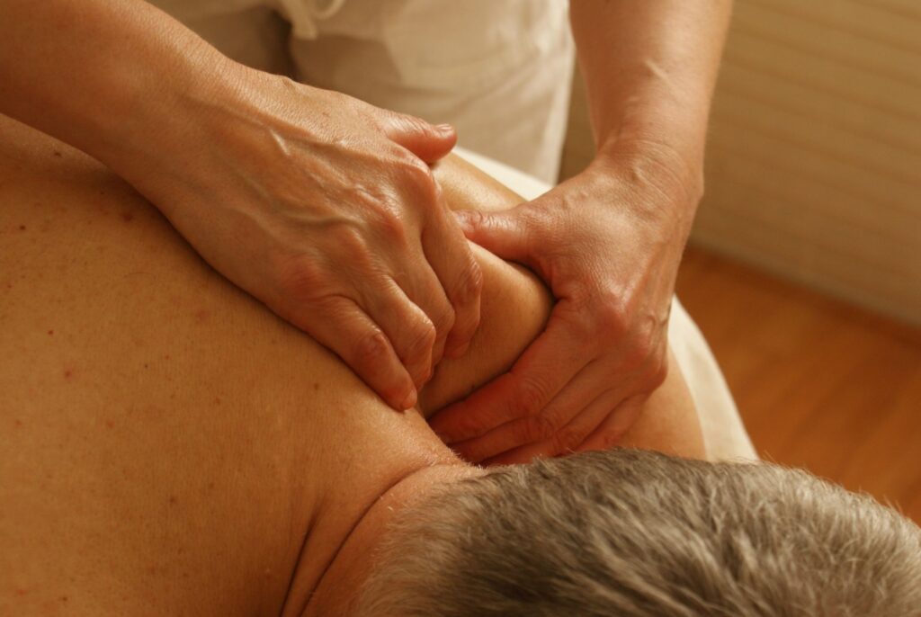 Deep tissue massage focusing on upper back and shoulder area