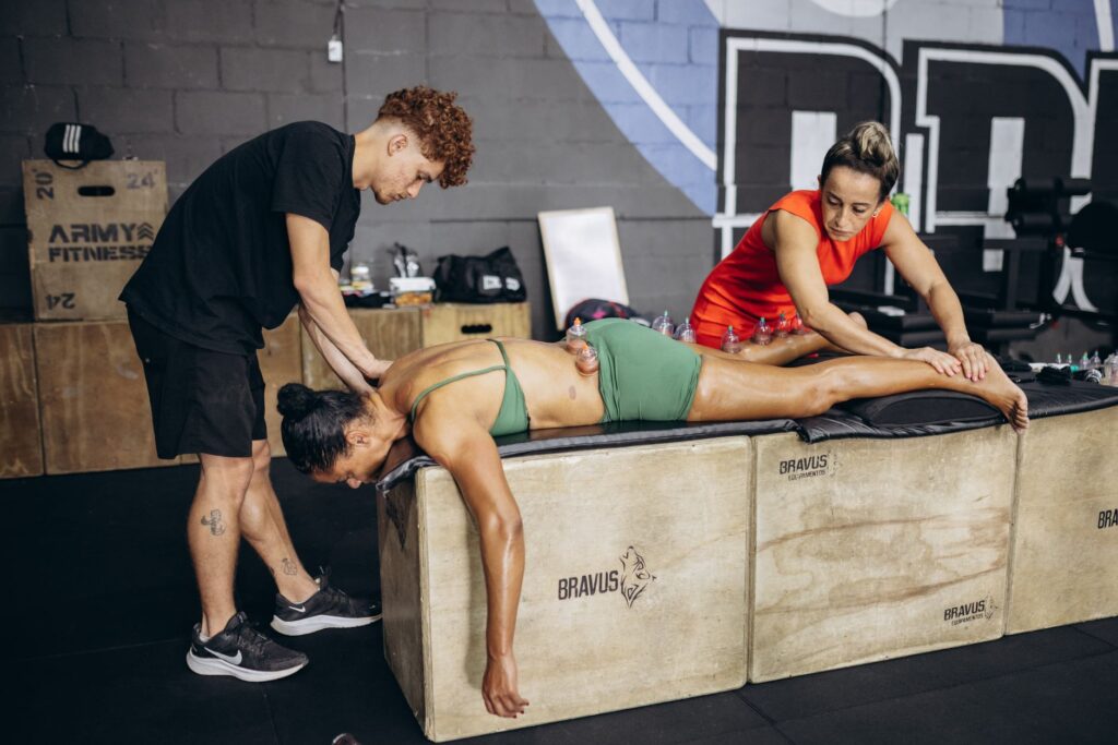 Deep tissue massage being performed on muscular athlete