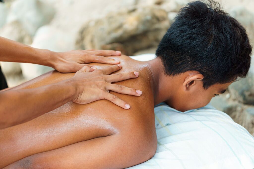 Person in relaxed state during soothing massage treatment