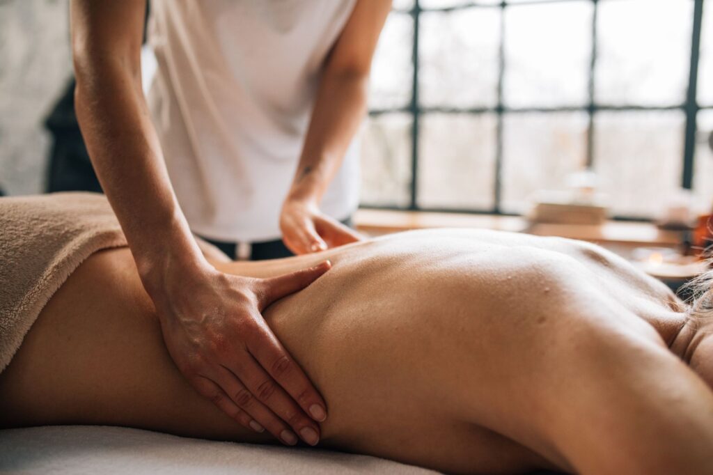 Spa massage session with candles and aromatherapy setup